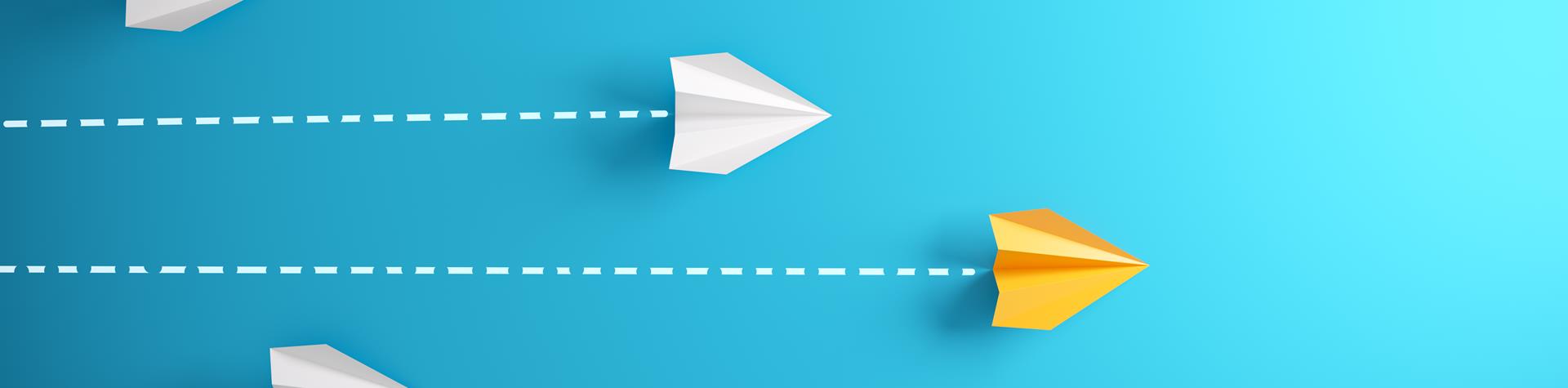 Paper aeroplanes with yellow in front