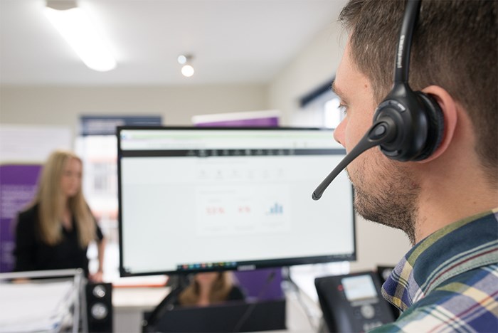 BCarm helpdesk team on the phone to a client