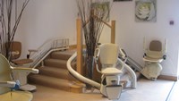 High end stair-lifts wrapping the edge of a rounded staircase