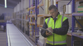 Health & Safety officer completing a checklist in a warehouse